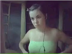 A woman with brown hair shows out her natural mambos for the webcam.